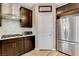Modern kitchen with stainless steel appliances, dark wood cabinets, and white quartz countertops at 1425 Overseer Ave, Henderson, NV 89074