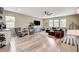Open concept living room with modern furniture, tile floors, and plenty of natural light at 1425 Overseer Ave, Henderson, NV 89074