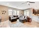 Open living space featuring sectional sofa, modern decor, and access to kitchen at 1425 Overseer Ave, Henderson, NV 89074