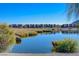 Calm pond reflecting the surrounding landscape and modern homes, enhancing the neighborhood's peaceful ambiance at 1425 Overseer Ave, Henderson, NV 89074