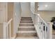 Carpeted staircase with white railing leading to the upper level of the home at 1425 Overseer Ave, Henderson, NV 89074