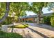 Spacious backyard with a mini-golf area and a brick house with a covered patio at 2001 Silver Ave, Las Vegas, NV 89102