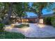 Backyard featuring a putting green, beautiful landscaping, mature trees, and covered patio at 2001 Silver Ave, Las Vegas, NV 89102