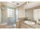 Bathroom featuring a glass shower, window for natural light, and neutral color tones at 2001 Silver Ave, Las Vegas, NV 89102