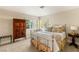 Cozy bedroom featuring a beautiful metal bed frame, a wooden armoire, and bright natural lighting from the windows at 2001 Silver Ave, Las Vegas, NV 89102