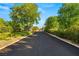 Long, paved driveway leading to a charming brick home with mature landscaping and a sense of privacy at 2001 Silver Ave, Las Vegas, NV 89102
