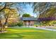 Charming single-story brick home with a lush, green lawn and mature trees, perfect for Gathering living at 2001 Silver Ave, Las Vegas, NV 89102
