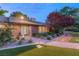 Charming brick home with a well-lit pathway and lush landscaping at dusk, creating a warm and inviting entrance at 2001 Silver Ave, Las Vegas, NV 89102