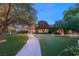Charming brick home with lush green lawn and stone pathway leading to the entrance at 2001 Silver Ave, Las Vegas, NV 89102