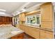 Spacious kitchen with custom cabinets, granite countertops, and a large window with backyard views at 2001 Silver Ave, Las Vegas, NV 89102