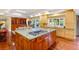 Gourmet kitchen features a large island with cooktop and seating, custom cabinets, and granite counters at 2001 Silver Ave, Las Vegas, NV 89102