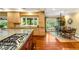 Gourmet kitchen with modern appliances, granite countertops, large island, and adjacent dining area at 2001 Silver Ave, Las Vegas, NV 89102