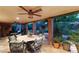 Covered patio with a dining set, ceiling fans, and brick columns, perfect for outdoor entertaining at 2001 Silver Ave, Las Vegas, NV 89102