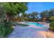 Inviting backyard pool with a slide, surrounded by lush landscaping and a tranquil seating area at 2001 Silver Ave, Las Vegas, NV 89102
