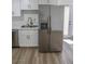 Updated kitchen with stainless steel refrigerator, white cabinets, and marble countertops at 2711 Sesame Dr, Las Vegas, NV 89142