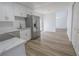 An open concept kitchen with stainless steel appliances and wood-look flooring at 2711 Sesame Dr, Las Vegas, NV 89142