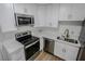 Bright kitchen showcasing stainless steel appliances, white cabinetry, and marble countertops at 2711 Sesame Dr, Las Vegas, NV 89142