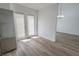 Open living area with staircase, wood-look flooring and access to backyard at 2711 Sesame Dr, Las Vegas, NV 89142