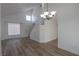 Bright living room with vaulted ceiling, wood floors, and modern chandelier at 2711 Sesame Dr, Las Vegas, NV 89142