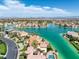 Aerial view of a waterfront neighborhood featuring many homes along canals, palm trees, and blue skies at 2925 Coast Line Ct, Las Vegas, NV 89117