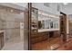 Lavish primary bathroom features natural light, wood floors, dual vanity, and large glass walk-in shower at 2925 Coast Line Ct, Las Vegas, NV 89117