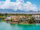 Homes on canals with mountain views and boats in the water of this lush green waterfront community at 2925 Coast Line Ct, Las Vegas, NV 89117