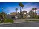 Stunning home featuring a tiled roof, palm trees, landscaped yard, and a paved driveway to attached garage at 2925 Coast Line Ct, Las Vegas, NV 89117