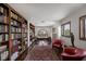 Home library featuring walls of bookshelves, a desk, and a comfortable seating area at 2925 Coast Line Ct, Las Vegas, NV 89117