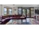 Cozy living room with lake view, large sectional sofa, and access to outdoor balcony at 2925 Coast Line Ct, Las Vegas, NV 89117
