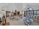 Cozy living room boasts vaulted ceilings, a fireplace, and large shuttered windows for plenty of light at 2925 Coast Line Ct, Las Vegas, NV 89117
