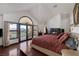 Serene main bedroom with balcony, fireplace, and views of the waterfront at 2925 Coast Line Ct, Las Vegas, NV 89117