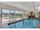 Indoor pool room features a waterfall feature, clear views of the neighborhood, and ample space at 2925 Coast Line Ct, Las Vegas, NV 89117