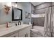 Stylish bathroom featuring modern tile work, a sleek vanity with a marble countertop, and dark hardware at 3013 Roseville Way, Las Vegas, NV 89102