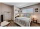 Comfortable bedroom featuring large window, decor, and hardwood flooring at 3013 Roseville Way, Las Vegas, NV 89102
