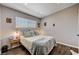 Comfortable bedroom featuring large window, decor, and hardwood flooring at 3013 Roseville Way, Las Vegas, NV 89102