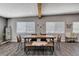 Spacious dining area featuring a rustic wood table, leather chairs, and modern accents at 3013 Roseville Way, Las Vegas, NV 89102