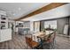 Open-concept kitchen and dining area featuring a rustic wood table and modern gray island at 3013 Roseville Way, Las Vegas, NV 89102