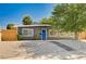 Charming single-story home with a blue front door and manicured desert landscaping at 3013 Roseville Way, Las Vegas, NV 89102