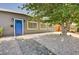 Charming single-story home with mature tree and gravel landscaping, featuring a blue front door at 3013 Roseville Way, Las Vegas, NV 89102