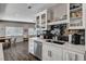 This kitchen features white cabinets, stainless steel appliances and a black tiled backsplash at 3013 Roseville Way, Las Vegas, NV 89102