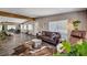 Large living room with hardwood floors, leather furniture and an open concept dining room at 3013 Roseville Way, Las Vegas, NV 89102