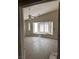 Bright bedroom with bay window, ceiling fan, neutral walls, and wood-look floors at 3051 S Rainbow Ave, Pahrump, NV 89048