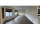 Large living room with natural light, neutral walls, blinds, and wood-look flooring at 3051 S Rainbow Ave, Pahrump, NV 89048