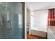 Modern bathroom with a glass enclosed shower and separate soaking tub at 3200 Mariner Bay St, Las Vegas, NV 89117