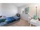 A bright carpeted bedroom with a window for natural light and a comfortable space for relaxation and personalization at 3200 Mariner Bay St, Las Vegas, NV 89117