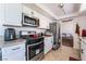 Updated kitchen with stainless steel appliances, white cabinets, and granite countertops at 3200 Mariner Bay St, Las Vegas, NV 89117