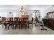 Multipurpose room featuring dining table, a fireplace, and fitness equipment under a chandelier at 3200 Mariner Bay St, Las Vegas, NV 89117