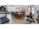 Multipurpose living space featuring a fireplace, dining table, and fitness equipment at 3200 Mariner Bay St, Las Vegas, NV 89117