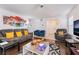 Open living room with hardwood floors, contemporary furnishings, and an open flow to the entryway at 3200 Mariner Bay St, Las Vegas, NV 89117