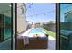 Backyard oasis showcasing a sparkling pool, patio seating, string lights, and barbecue area at 3369 Ponicelli Ln, Henderson, NV 89044